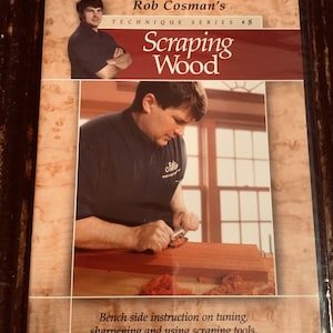 May include: DVD case for Rob Cosman's Technique Series #8, "Scraping Wood." The cover features a photo of a man working with wood and the title in large red letters. The bottom text reads, "Bench side instruction on tuning, sharpening and using scraping tools."