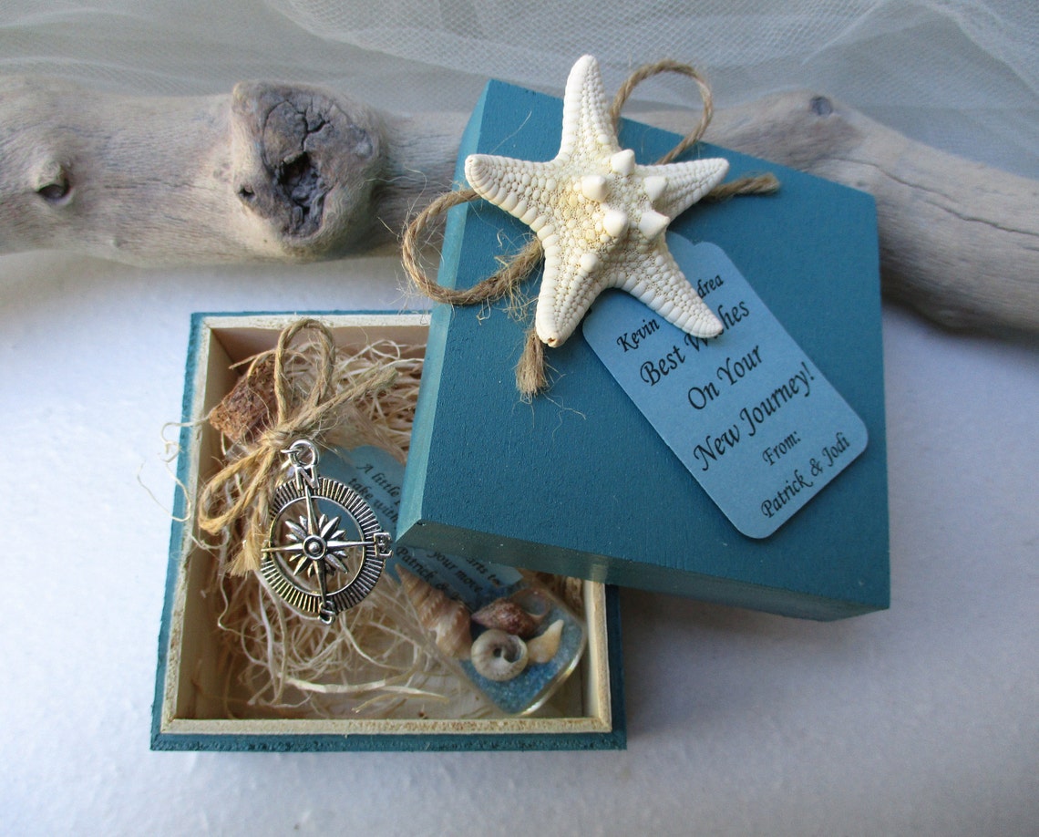 The beach gift box includes a bottle filled with sand, small shells, and a personalized message tag.