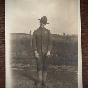 Antique Snapshot Photo Smiling WWI Soldier In Uniform Posing In Desolate Area