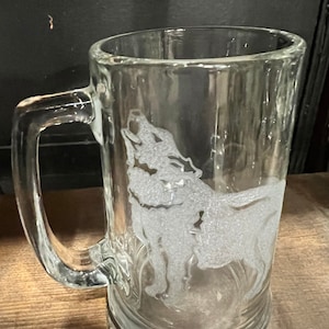 May include: A clear glass beer stein with a frosted etching of a wolf howling at the moon.