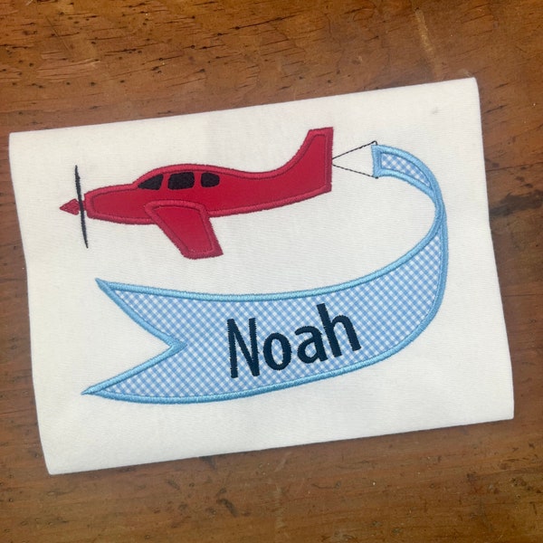 Airplane pulling a banner to customize  applique embroidery design  for use in an Embroidery machine