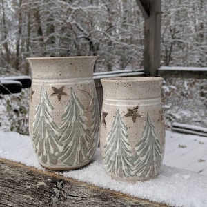 Small votive candle holder with winter trees scene.