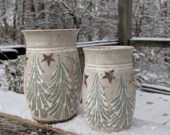 Small votive candle holder with winter trees scene.