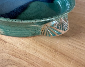 stoneware baking dish with mountain pattern on handles