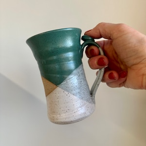 Tall pottery coffee mug with thumb rest