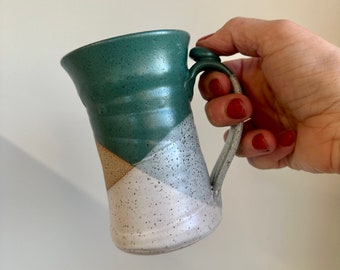 Tall pottery coffee mug with thumb rest