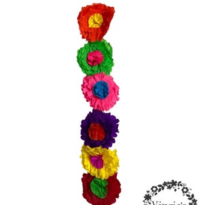 May include: A vertical arrangement of six colorful paper flowers. The flowers are in shades of red, green, pink, purple, yellow, and red. Each flower has a contrasting center, and the arrangement is set against a white background.