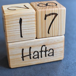 May include: Wooden blocks spelling out "17 Hafta" in black lettering. The blocks are stacked on top of each other.
