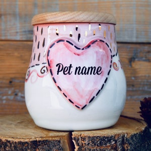May include: White ceramic pet food jar with a pink heart design. The heart has a black stitched outline and the words "Pet name" written in black.