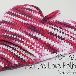 May include: A heart-shaped potholder in shades of pink, white, and purple, with a loop for hanging. The crochet design features diagonal stripes. The text "Feel the Love Potholder" is visible.