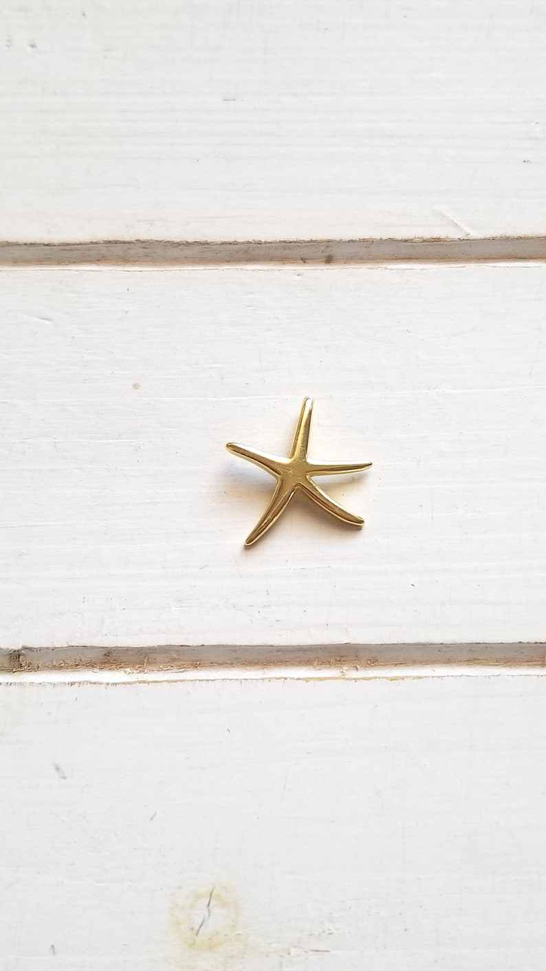 May include: A gold-colored starfish charm pendant.
