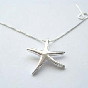 May include: A silver chain necklace with a silver starfish pendant.