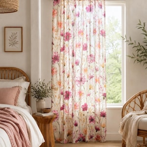 May include: A sheer window curtain panel featuring a botanical print with various wildflowers in shades of pink, magenta, and soft orange on a cream-colored background. The curtain is hung on a black rod and covers a window, allowing light to filter through the fabric.