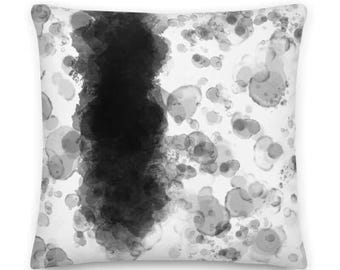May include: Black and white abstract pillow with a vertical black stripe and white circles.