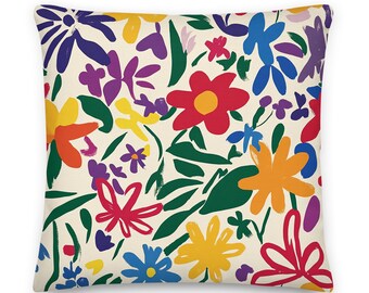 May include: A cream-colored pillow with a colorful floral pattern. The flowers are painted in a variety of colors, including red, yellow, orange, blue, green, and purple. The pillow is perfect for adding a touch of color and whimsy to any room.