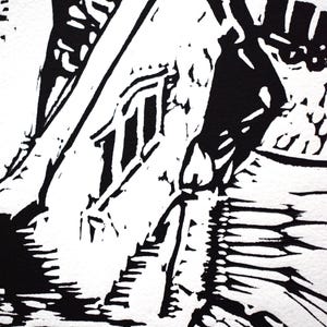 The image shows a detail of the print. Here are the parts  of the building's roof and a chimney. There are also three windows on the front of the house.