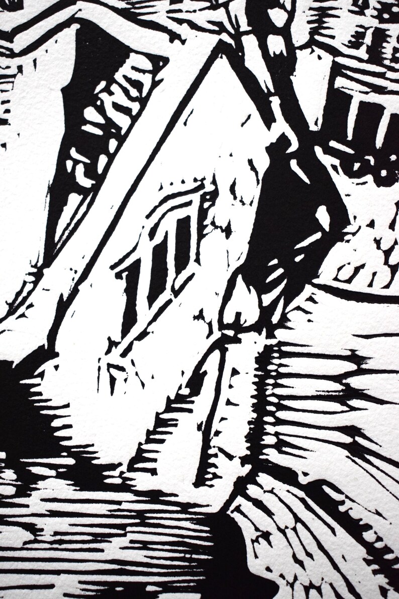 The image shows a detail of the print. Here are the parts  of the building's roof and a chimney. There are also three windows on the front of the house.