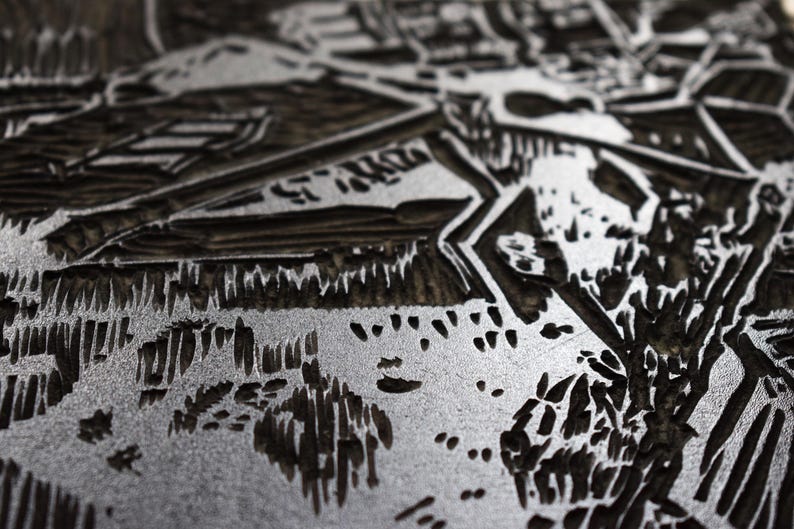 The image shows a part of the printmaking process. Linocut is a printing technique that requires carving in linoleum block. After carving you put a layer of the color and print it. This image shows the inked matrix.