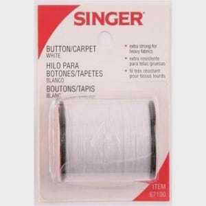 May include: A spool of white Singer button and carpet thread packaged on a rectangular card. The packaging features the brand name Singer at the top, the text Button/Carpet White, and the item number 67100. The thread is extra strong.