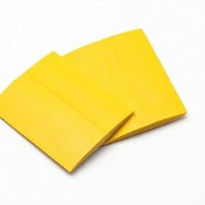 May include: Three yellow rectangular pieces of paper, stacked on top of each other.