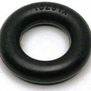 May include: Black rubber O-ring with the number "11528 TA" printed on the outside.