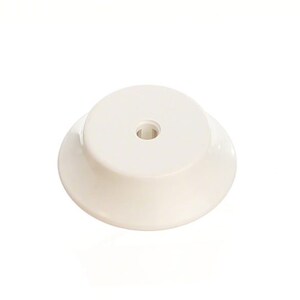 May include: White plastic base with a round top and a small hole in the center. The base is designed to be used as a stand for a variety of objects.