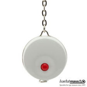 May include: A white round retractable tape measure with a red button and a silver chain. The tape measure has the text "hartstoff mass®" printed on the bottom.