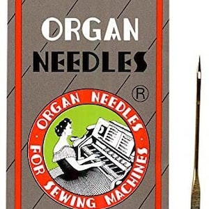 May include: A package of Organ sewing machine needles with a red and white label featuring a vintage illustration of a woman playing a piano. The label reads "Organ Needles for Sewing Machines" and "Organ Needle Co., Ltd."