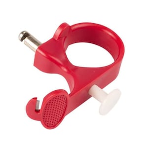 May include: Red plastic ring tool with a white button and a small metal pin. The tool is designed to help with the removal of rings.