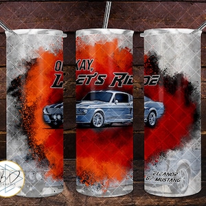 May include: A sublimation design for a tumbler featuring a gray Ford Mustang with the text "Okay, Let's Ride" and "Eleanor '67 Mustang". The design has a red, orange, and white paint splatter effect.