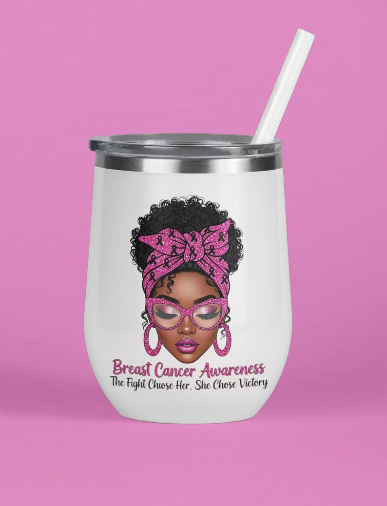 May include: White insulated tumbler with a silver rim and a white straw. The tumbler features an illustration of a woman with a pink headscarf, glasses, and earrings. Text on the tumbler reads "Breast Cancer Awareness: The Fight Chose Her, She Chose Victory."