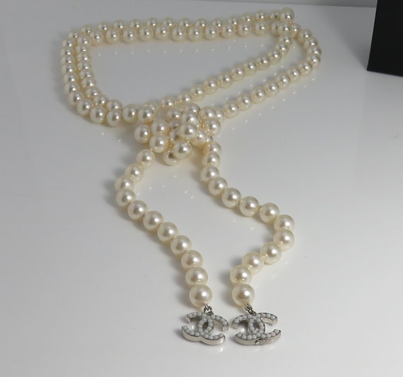 An Authentic Chanel Long Pearl Necklace with CC logos with Seed Pearls and  Crystals in original Box