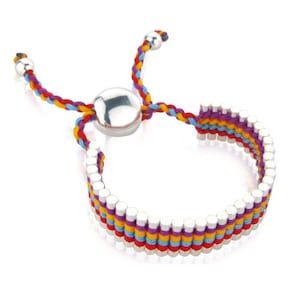 May include: A colourful braided bracelet with silver beads and a silver toggle clasp. The bracelet is made with red, yellow, blue, and purple threads.