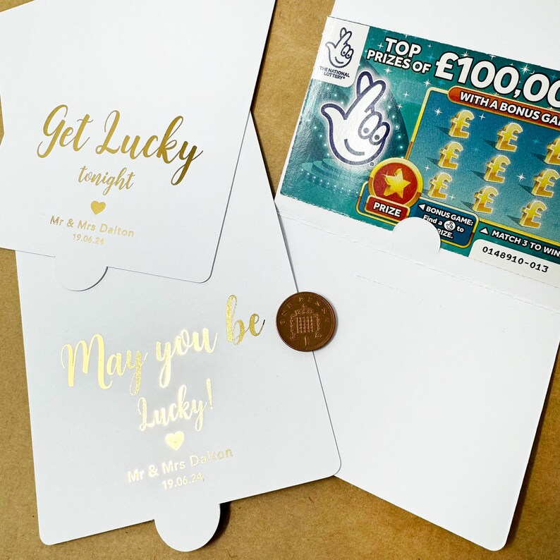 May include: A white card with gold lettering that reads "Get Lucky tonight" and "May you be Lucky!" with a small heart symbol and the text "Mr. & Mrs. Dalton" and the date "19.06.24".