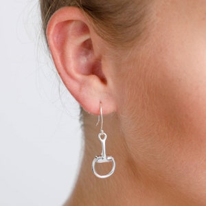 Puede incluir: Pendientes de plata con forma de bocado de caballo, un diseño popular de joyería ecuestre.