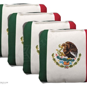 May include: Four bean bags with the Mexican flag design. Each bag has a white center with the Mexican coat of arms, green and red borders. The bags are stacked at a slight angle, showcasing the design.