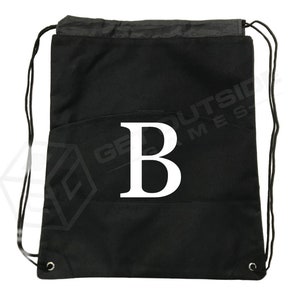 May include: Black drawstring bag with a white letter "B" printed on the front.