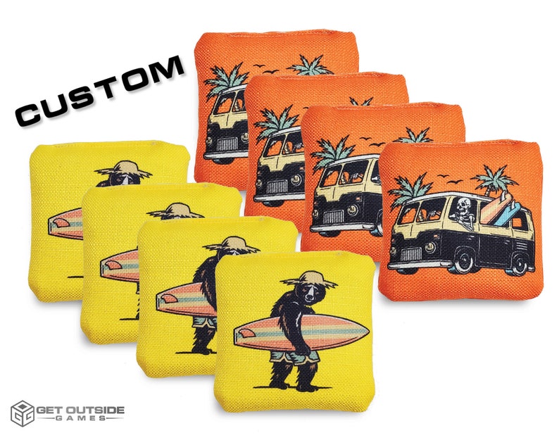 May include: Six yellow bean bags with a surfer bear design and three orange bean bags with a van design. The bean bags are for a game called 'CUSTOM'.