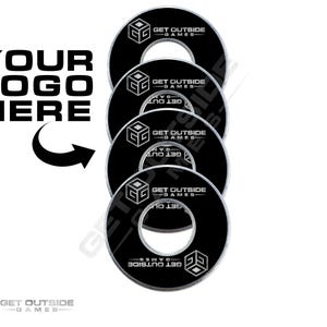 May include: A stack of black and white game discs with the text "GET OUTSIDE GAMES" and a geometric logo. The words "YOUR LOGO HERE" are above an arrow pointing to the discs. The discs have a hole in the center.