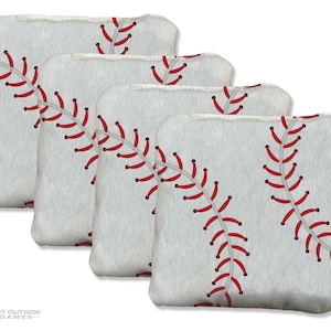 May include: Four white bean bags with red baseball stitching. The bean bags are arranged in a diagonal stack, with the baseball stitching design prominently displayed on each bag. The bags are for outdoor games.