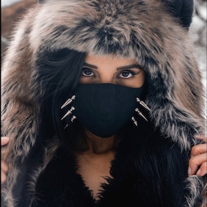 Spiked unisex face mask with adjustable ear straps.