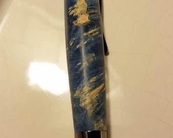 May include: A blue and white wood pen with a black metal cap and tip.