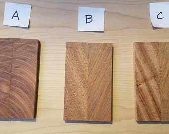 May include: Three pieces of wood with different grain patterns labeled A, B, and C. The wood is a light brown color with darker brown streaks.