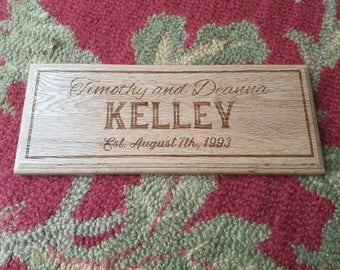 May include: A wooden sign with the text "Timothy and Deanna Kelley Est. August 7th, 1993" engraved on it.