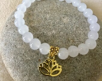 Snow Quartz. Soft Feminine Energy. Good luck Stone. Beaded Bracelet. Gold/Silver Lotus Charm. Gold/Silver Spacer Beads. Simple Stretch.