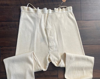May include: A pair of off-white thermal underwear with a button fly and ribbed cuffs.