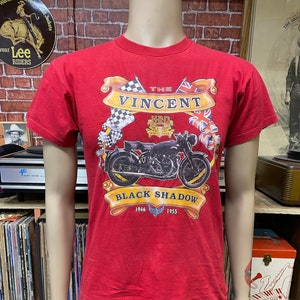 May include: Red t-shirt with a graphic of a black Vincent HRD Black Shadow motorcycle with the text "The Vincent HRD Black Shadow 1946 - 1955".