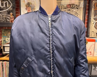 May include: A navy blue bomber jacket with a zipper closure and a ribbed collar. The jacket has a smooth, shiny finish.