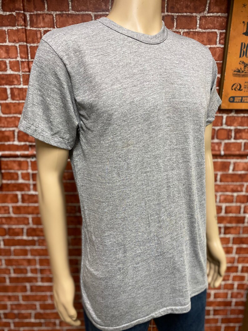 May include: A heather gray short-sleeved t-shirt with a crew neck.