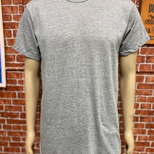 May include: A heather grey t-shirt with short sleeves and a crew neck.